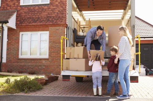 Local packers organising boxes in a Silvertown apartment